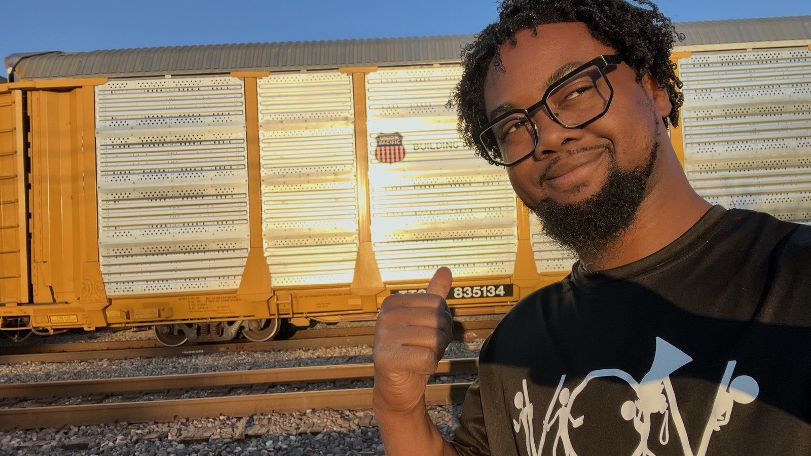 The same Union Pacific railcar with the graffiti fully removed, clean in the sunset light