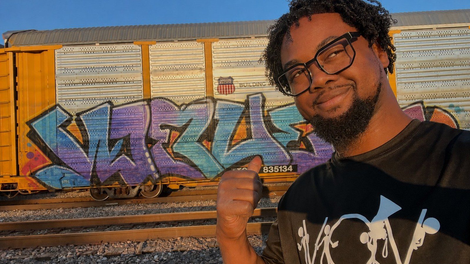 A Union Pacific railcar covered in graffiti