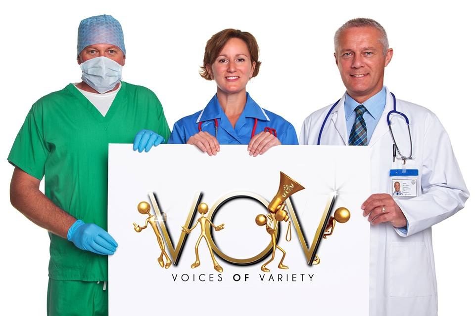 A surgeon, a nurse, and a doctor holding the Voices of Variety sign