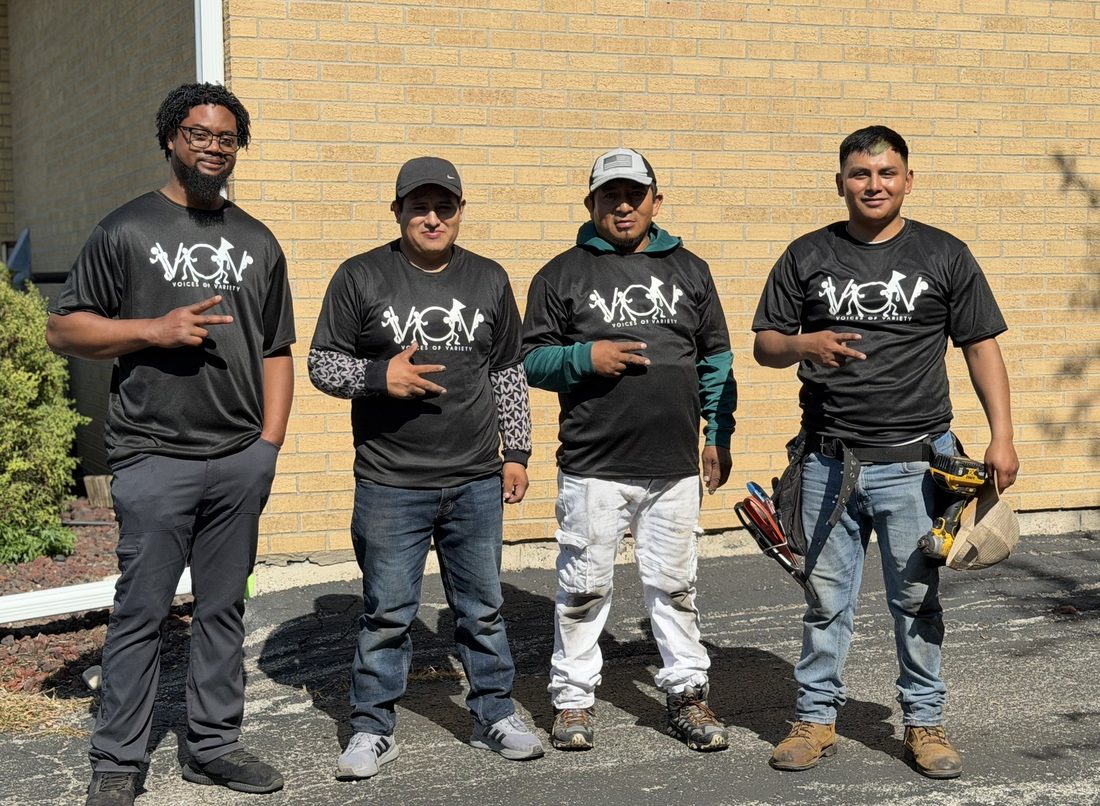 Four V.O.V crew members in matching shirts on a job site