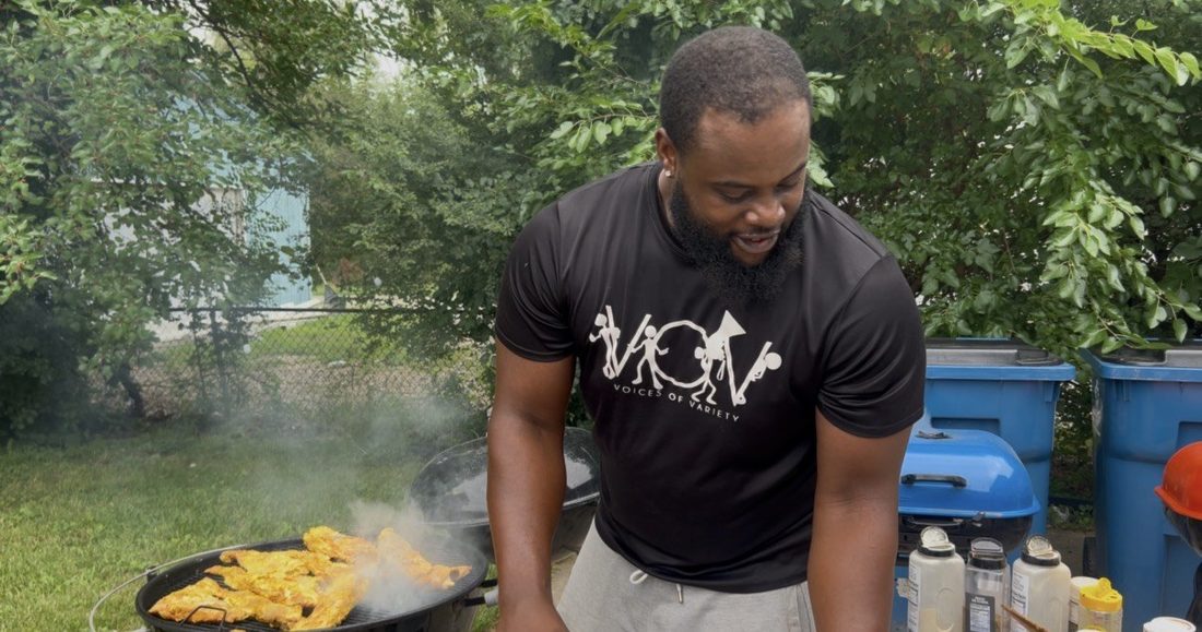 A V.O.V member grilling chicken for the crew