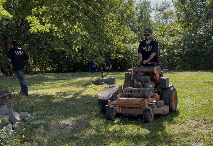 Two V.O.V crew members cutting a large yard