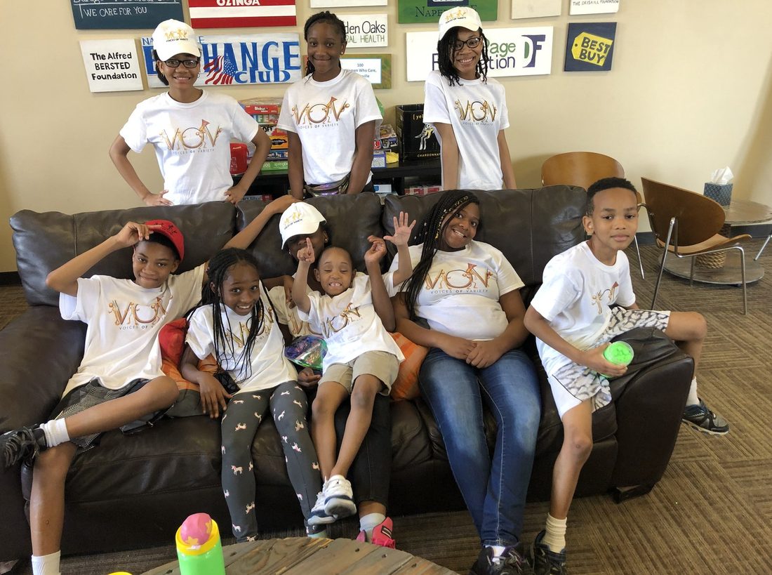 V.O.V kids in matching shirts and caps at a community club