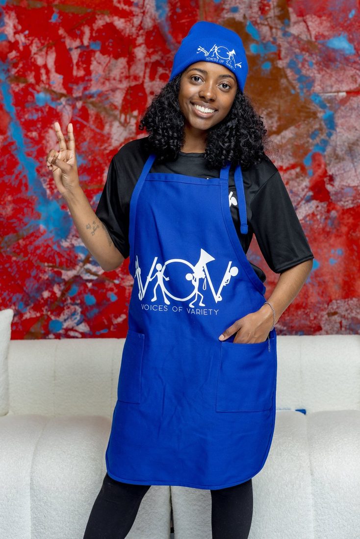 Model wearing the royal blue V.O.V apron and skull hat