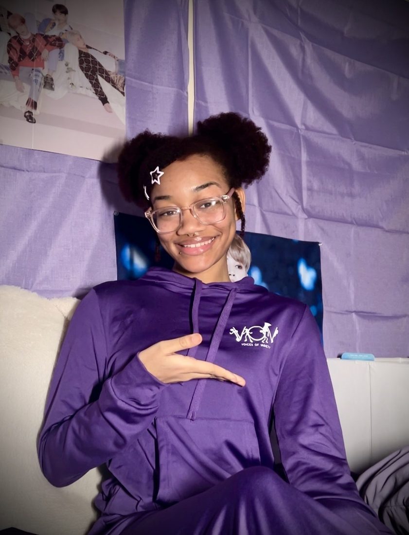 Model in the purple V.O.V hoodie and jogging set with the white chest logo