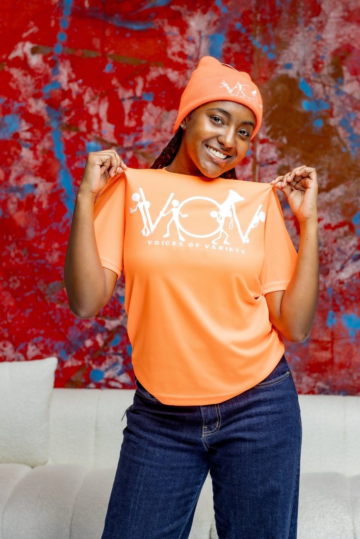 Model in the orange V.O.V dri-fit tee with matching orange skull hat