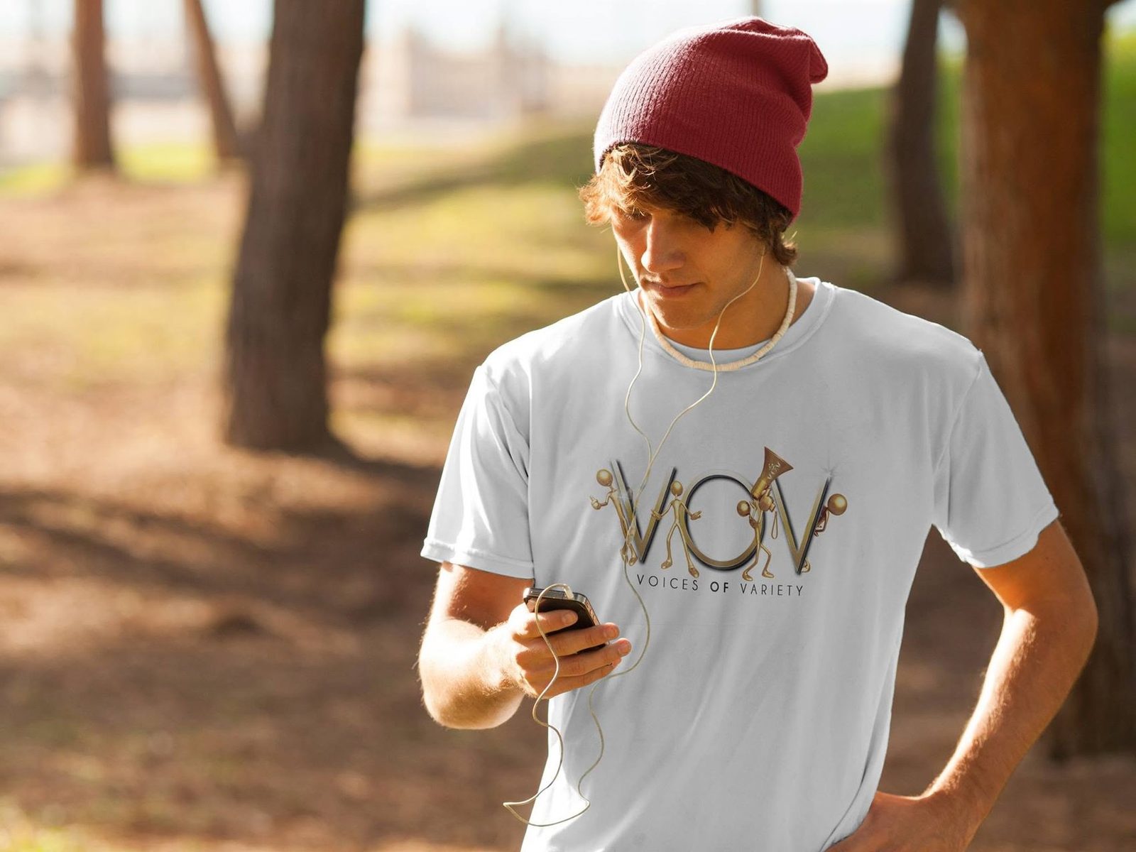 A young listener in a V.O.V t-shirt, earbuds in, taking the message with him