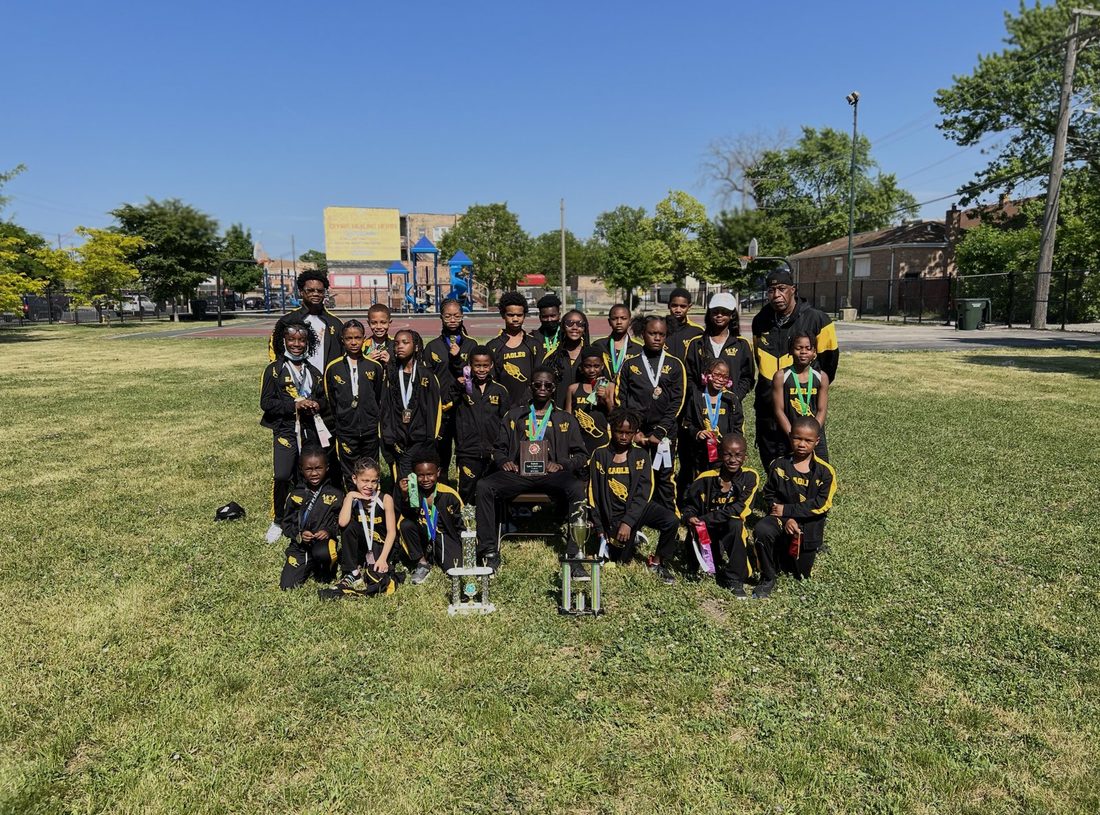 The V.O.V Eagles track team posing with their trophies