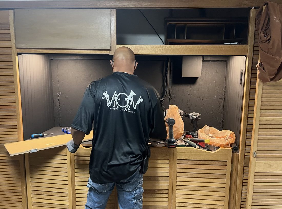A V.O.V member working at a cabinet bench