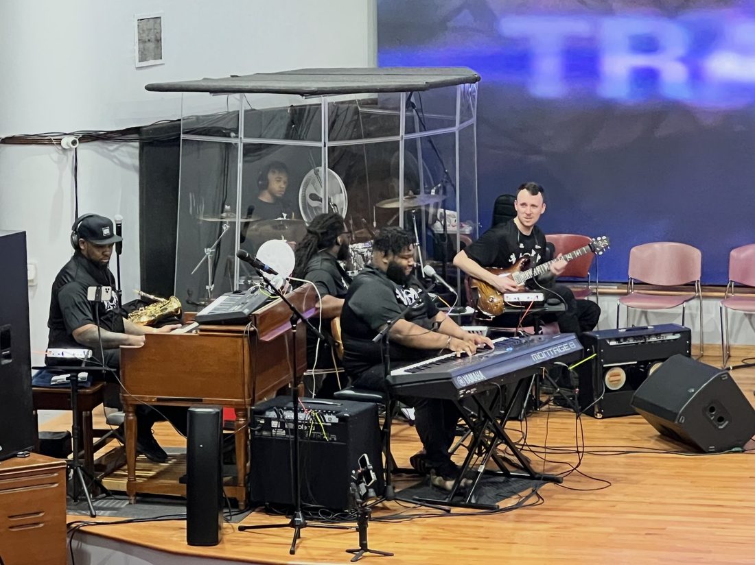 The V.O.V band on the organ and keys at a service