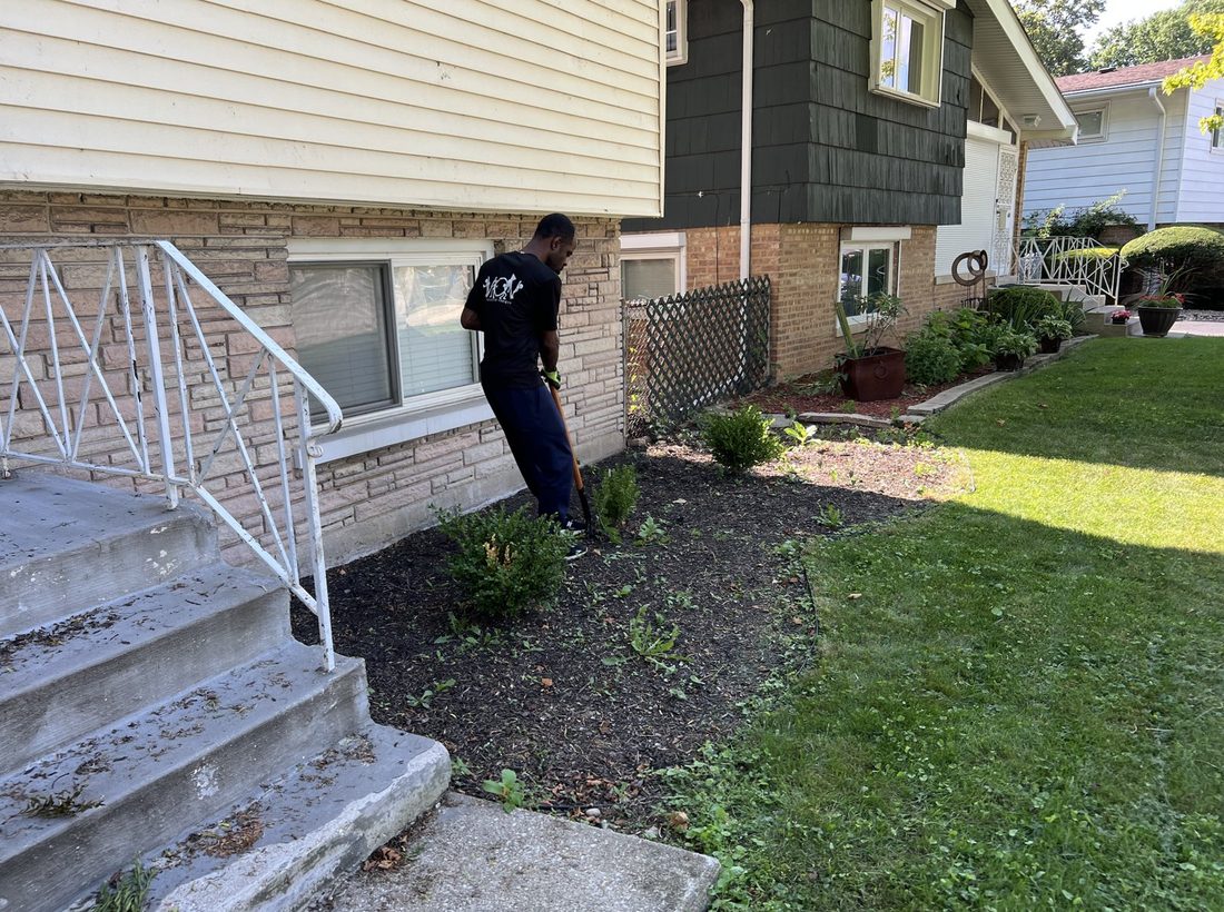A V.O.V member landscaping beside the front steps