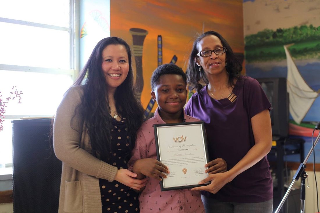 Lashawn's certificate - family looking on