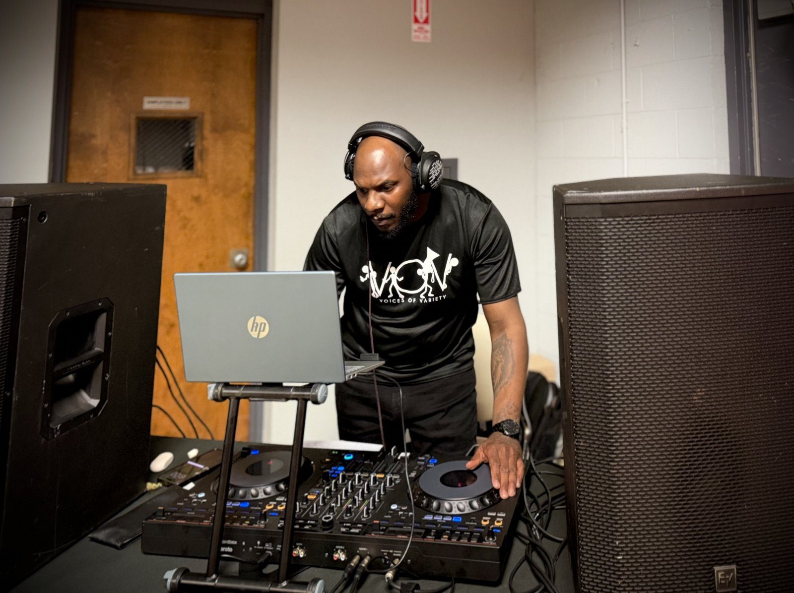 A V.O.V DJ running the decks at a community event