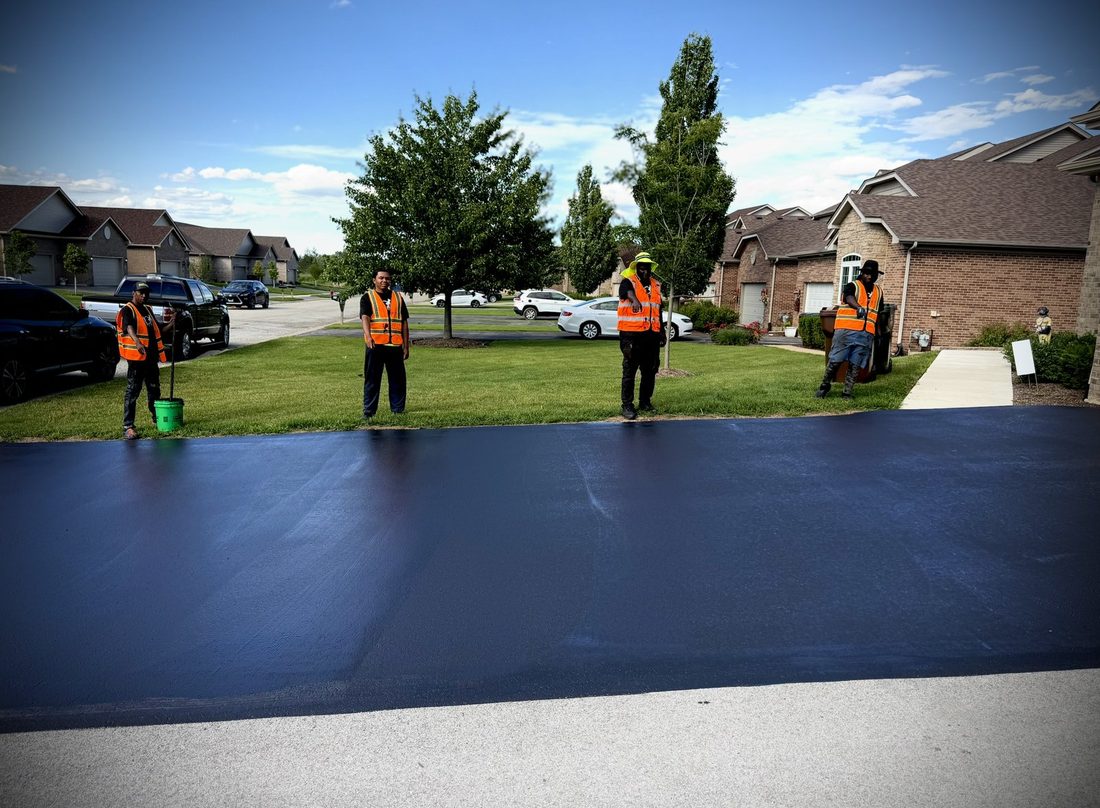 V.O.V crew standing on a freshly sealcoated driveway
