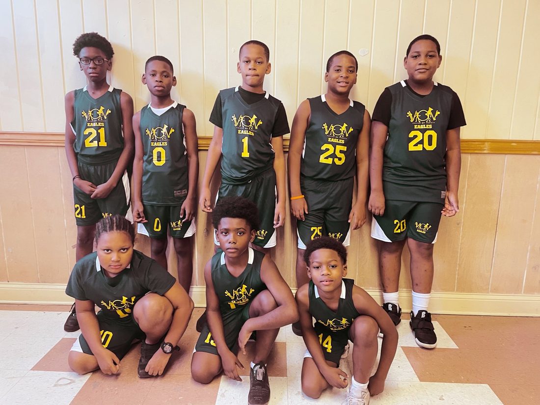 The V.O.V youth basketball squad in black and gold jerseys