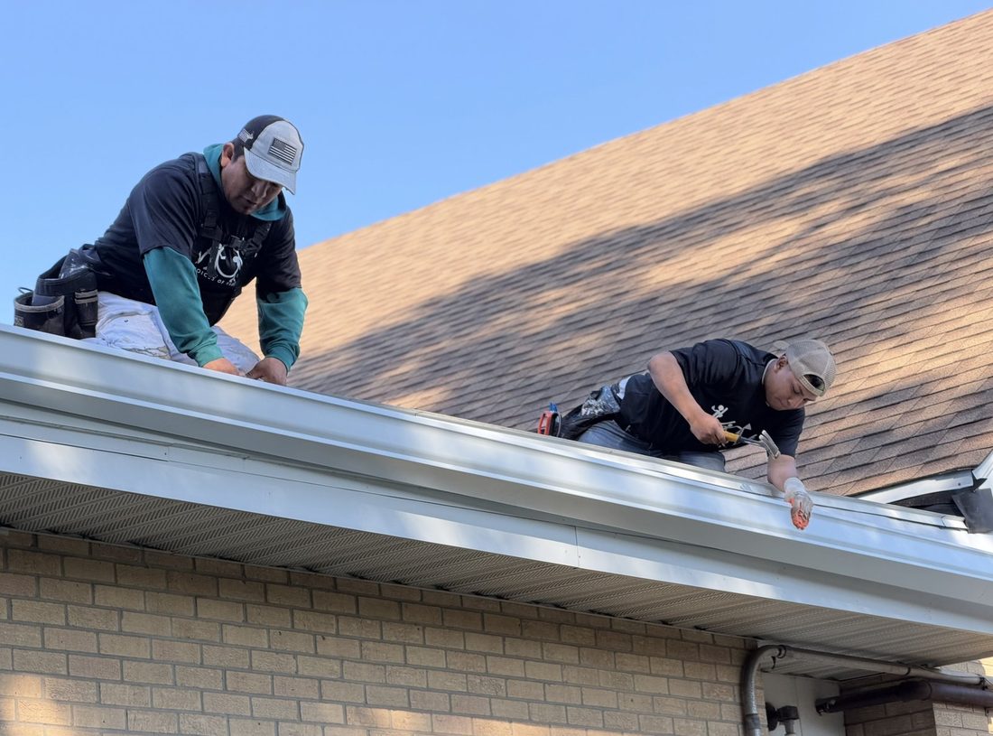 The V.O.V roofing crew working a shingle roof