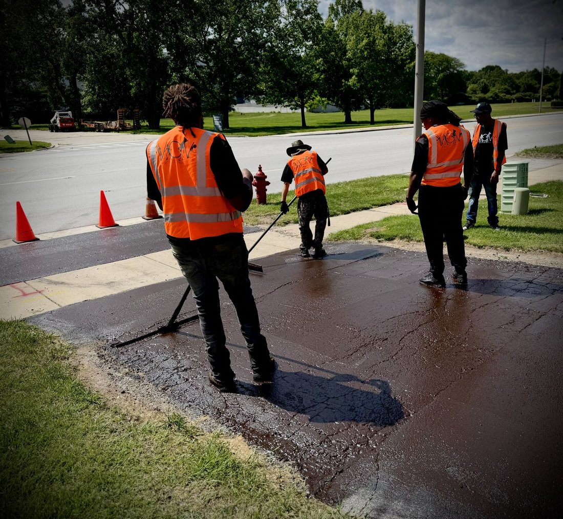 The V.O.V workforce crew sealcoating a neighborhood street