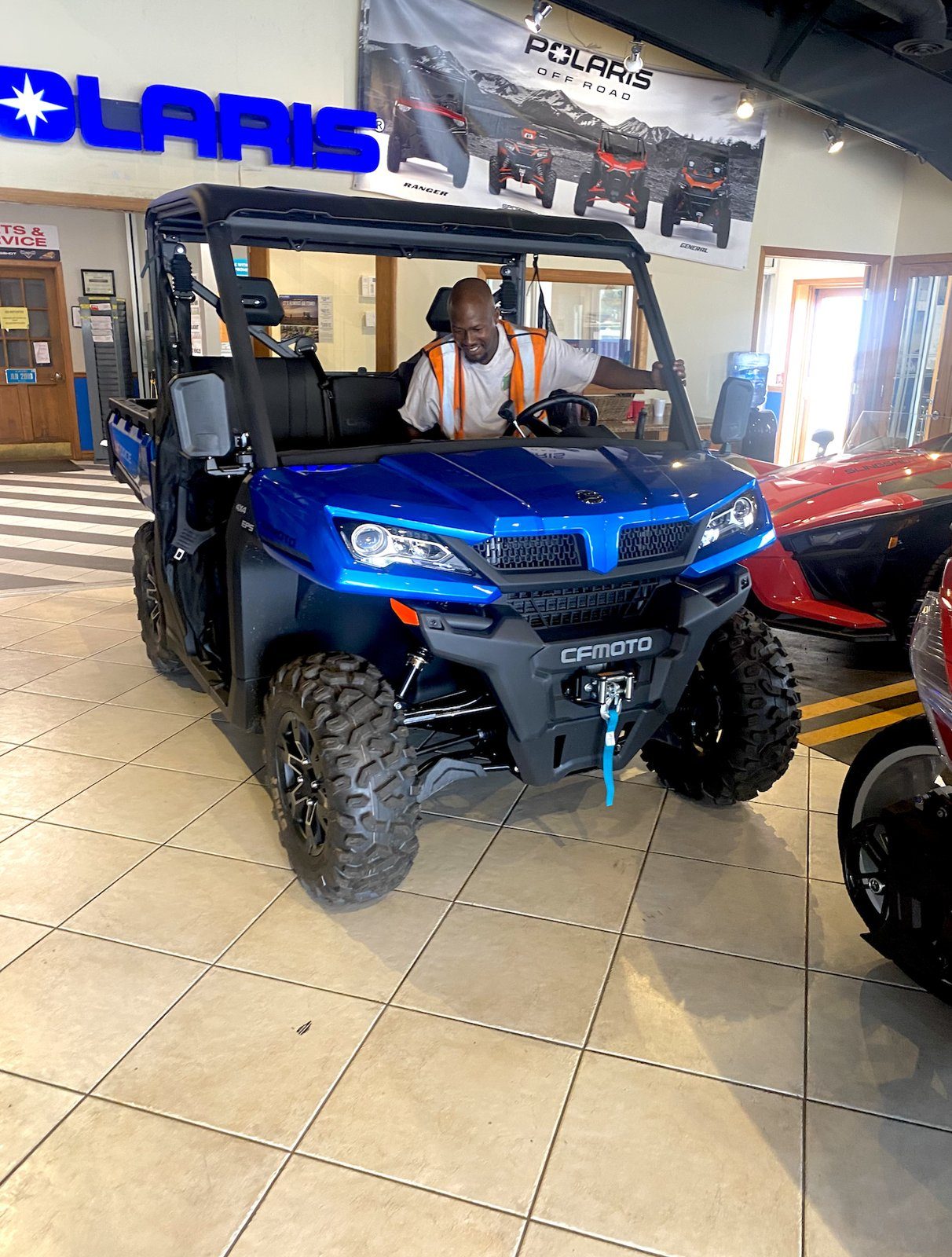 A V.O.V member with a new utility vehicle at the dealership