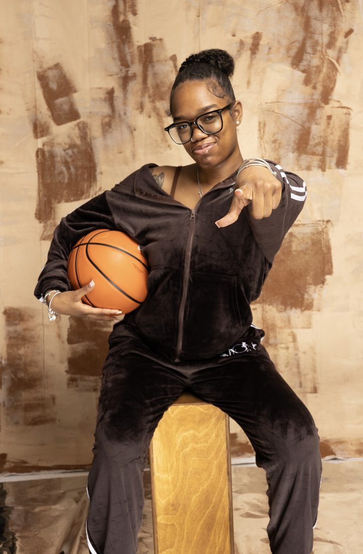 A V.O.V athlete posing with a basketball for a professional portrait