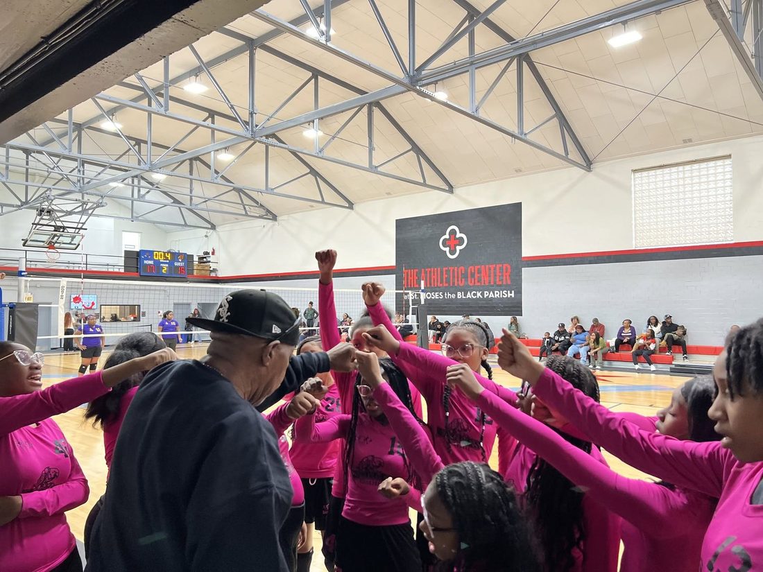 V.O.V volleyball team in a huddle