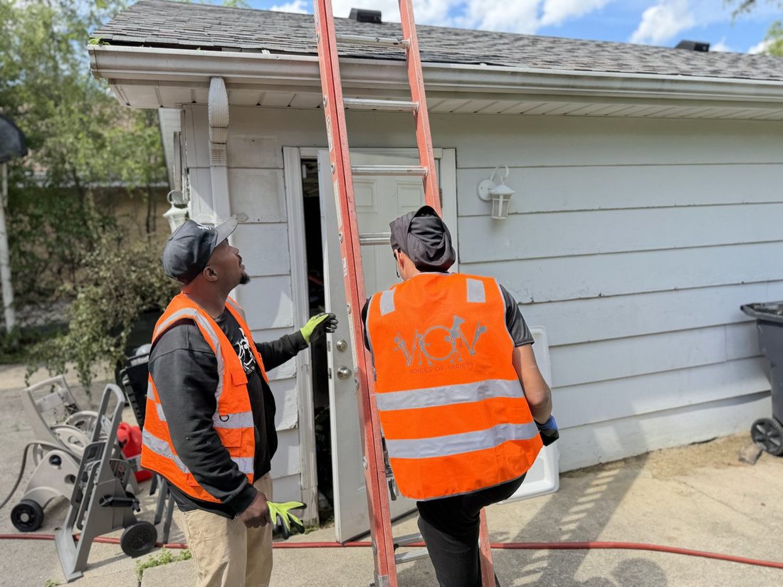 V.O.V crew in safety vests working on a home job site