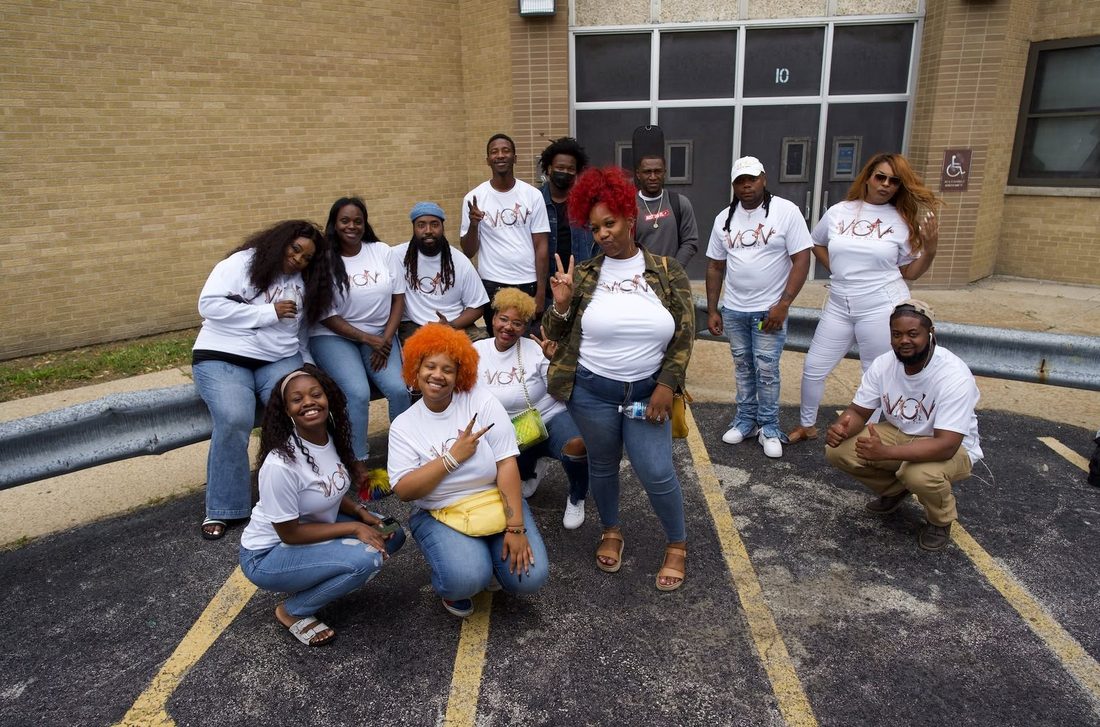 The V.O.V team in matching shirts outside a school