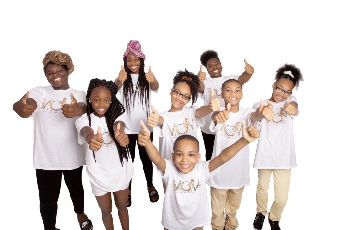 V.O.V youth in their Voices of Variety shirts giving thumbs up to the future