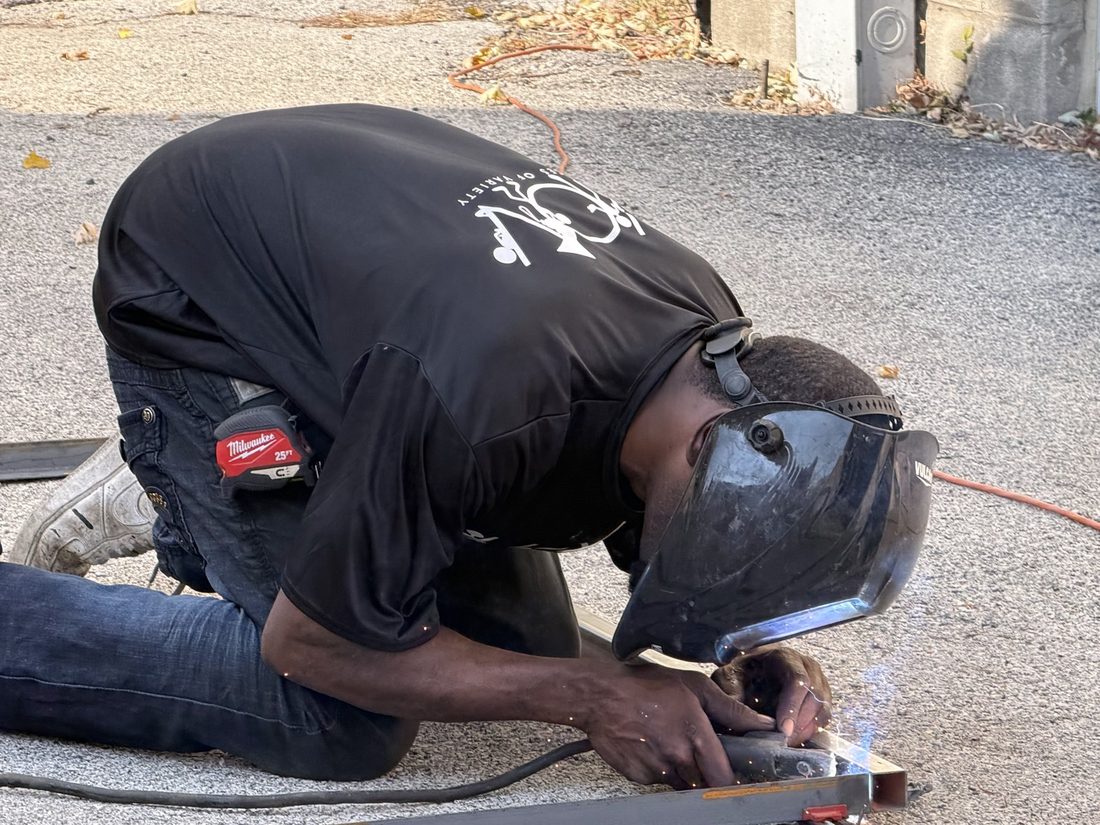 A V.O.V member welding &mdash; sparks flying as he learns a real trade